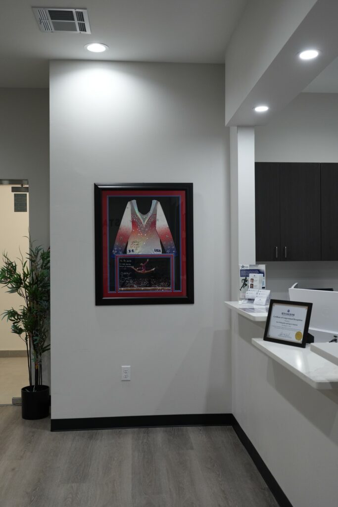 Reception area with a framed jersey at Star Orthopedics in Frisco