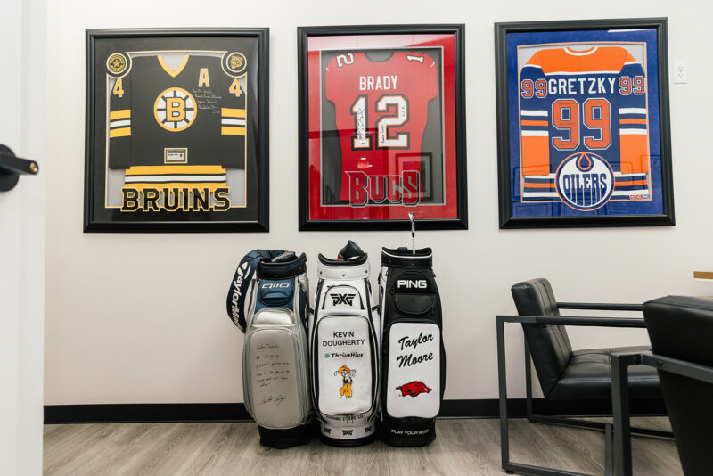 Dr. Dold's office with framed signed jerseys and signed golf bags