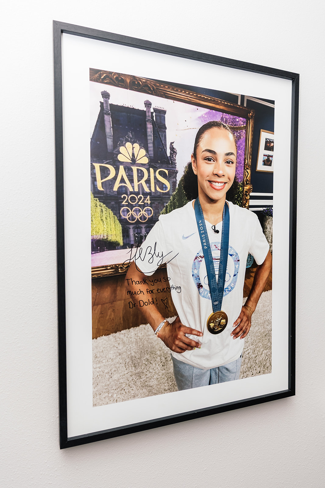 Signed Paris 2024 Olympic gymnastics photo with a note to Dr. Dold