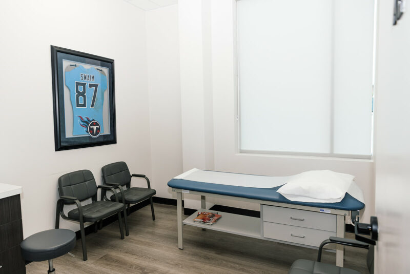 Exam room at Star Orthopedics in Frisco with a framed signed jersey