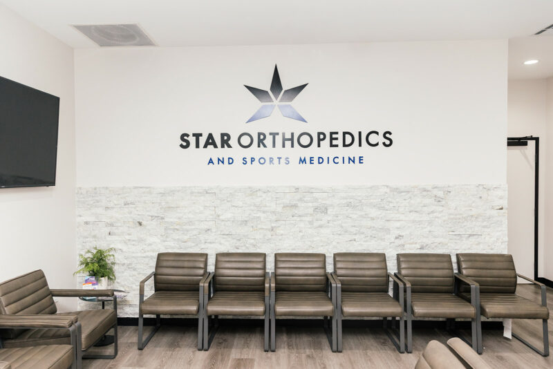 Waiting room with the Star Orthopedics and Sports Medicine logo wall